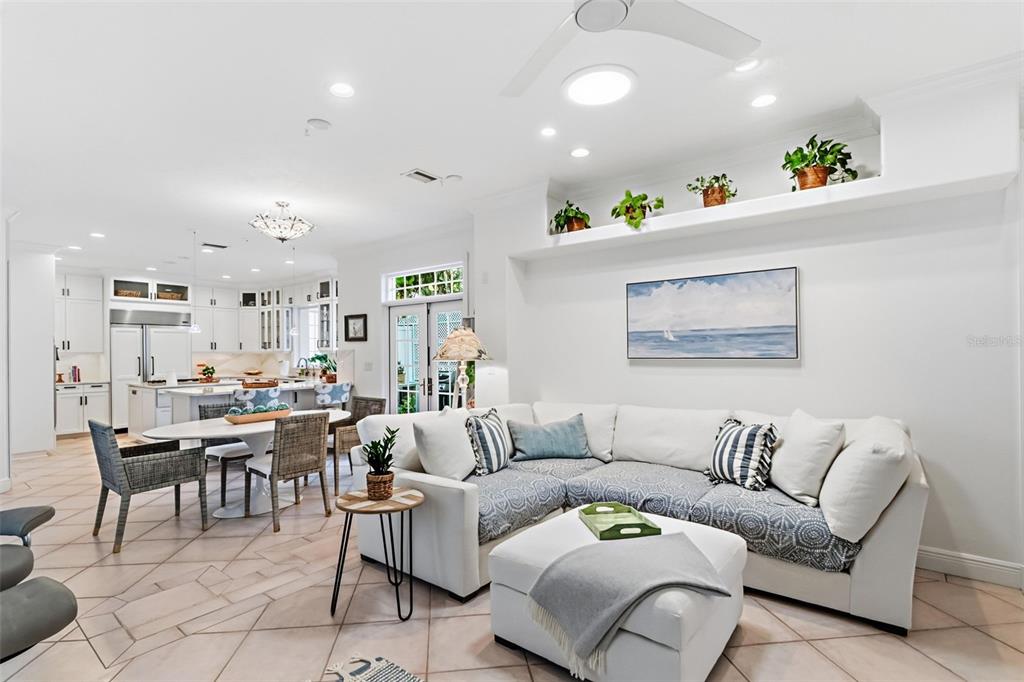 5382 Sandhamn Place Longboat Key, FL 34228 - Photo 19 of 55 a living room with furniture and a dining table with kitchen view