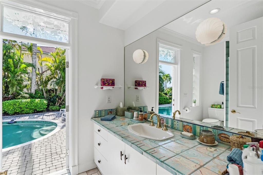 5382 Sandhamn Place Longboat Key, FL 34228 - Photo 23 of 55 a bathroom with a granite countertop sink and a mirror