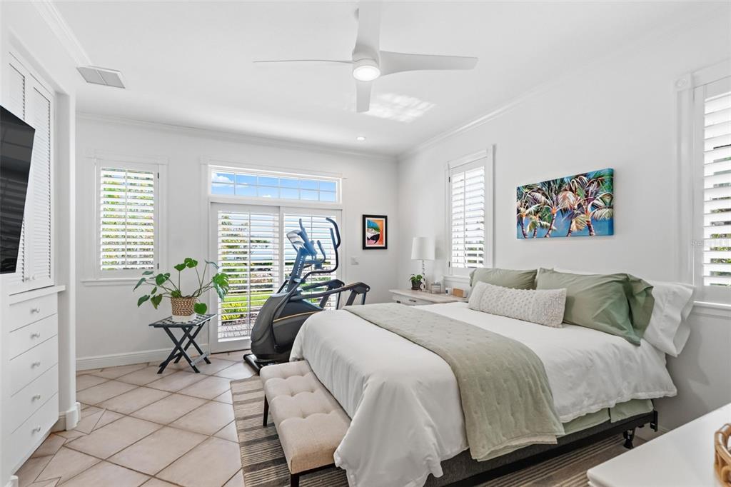5382 Sandhamn Place Longboat Key, FL 34228 - Photo 24 of 55 a bedroom with a bed and large windows