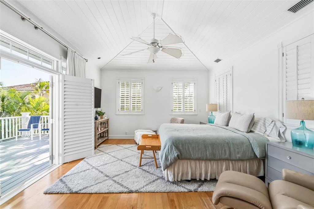 5382 Sandhamn Place Longboat Key, FL 34228 - Photo 25 of 55 a bedroom with a bed and wooden floor