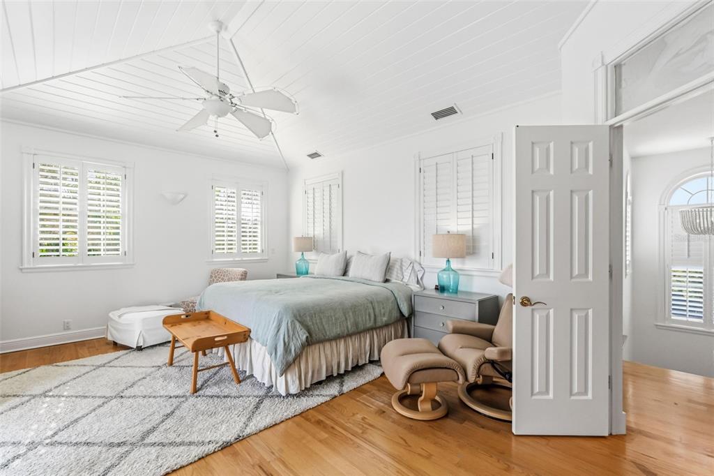 5382 Sandhamn Place Longboat Key, FL 34228 - Photo 26 of 55 a bedroom with furniture and a window