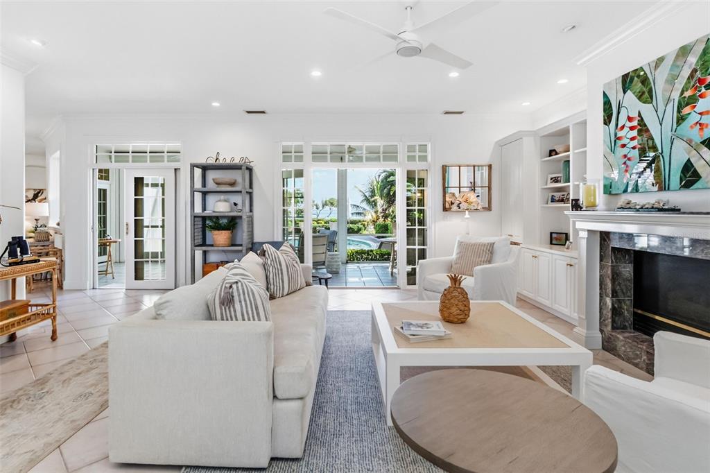 5382 Sandhamn Place Longboat Key, FL 34228 - Photo 3 of 55 a living room with furniture fireplace and flat screen tv