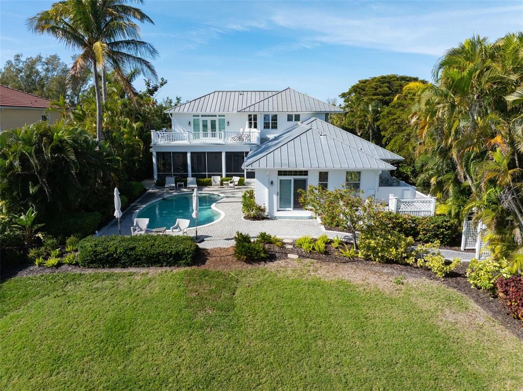 5382 Sandhamn Place Longboat Key, FL 34228 - Photo 49 of 55 a front view of a house with garden