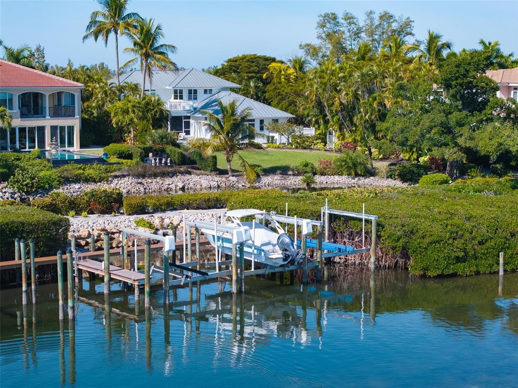 5382 Sandhamn Place Longboat Key, FL 34228 - Photo 51 of 55 a view of house with swimming pool yard and outdoor seating