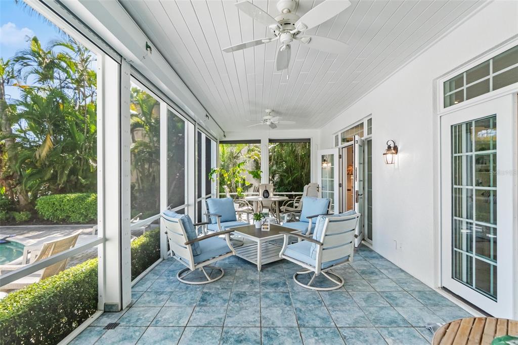 5382 Sandhamn Place Longboat Key, FL 34228 - Photo 6 of 55 a view of a patio with table and chairs and potted plants
