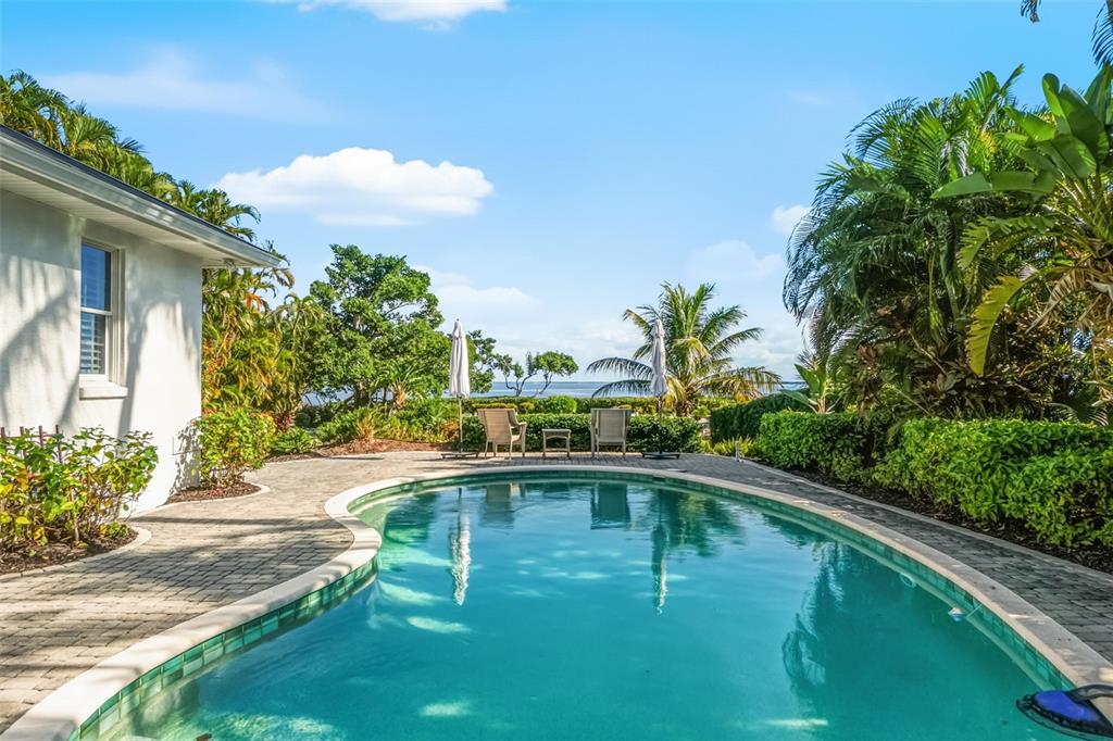5382 Sandhamn Place Longboat Key, FL 34228 - Photo 9 of 55 a swimming pool view with a garden space