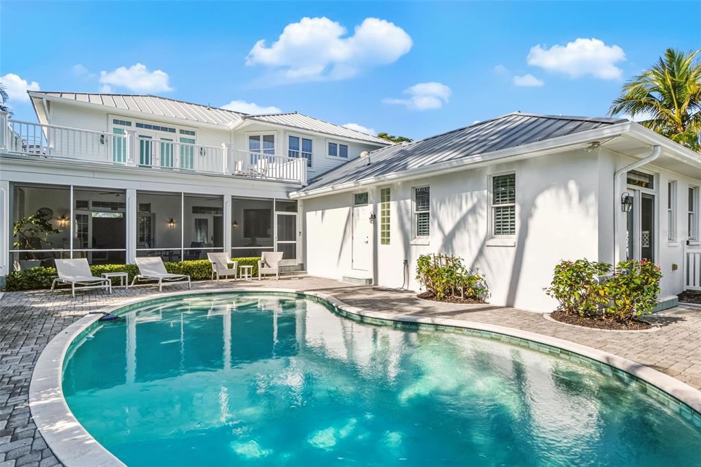 5382 Sandhamn Place Longboat Key, FL 34228 - Photo 10 of 55 a view of a house with sitting area and swimming pool