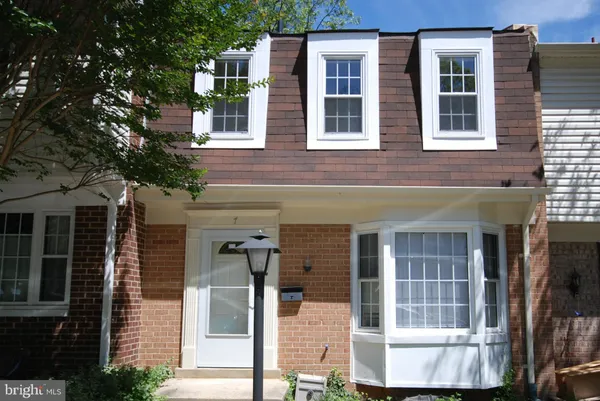 a view of a brick house with a large windows