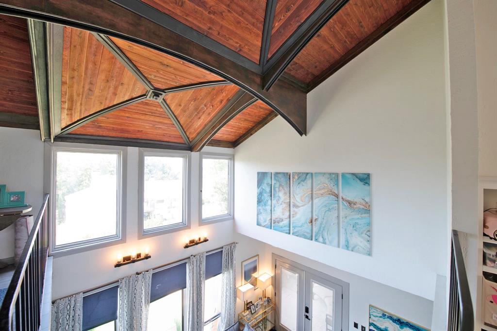 Detailed view of a wood ceiling with exposed beams and french doors