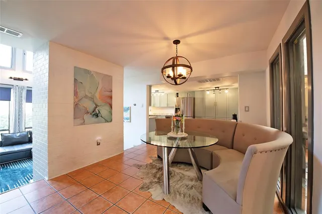 a dining room with furniture and wooden floor