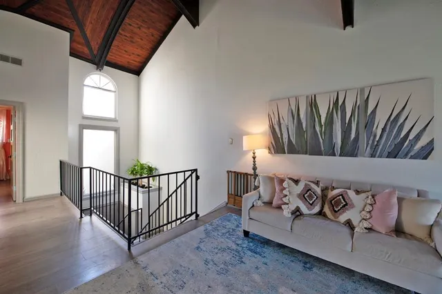 a white couch sitting in a living room next to a window