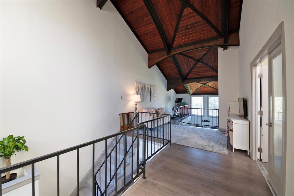 3915 Roma Court Rockwall, TX 75087 - Photo 17 of 40 Hallway featuring an upstairs landing, a wooden ceiling with exposed beams, wood finished floors, and high vaulted ceiling