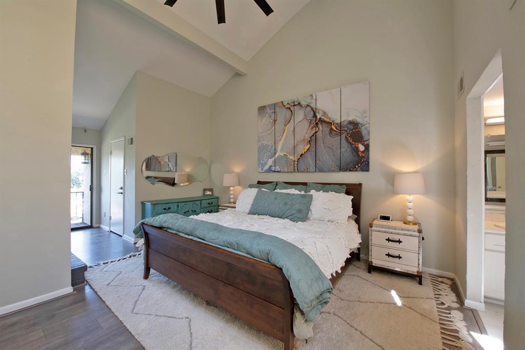 3915 Roma Court Rockwall, TX 75087 - Photo 20 of 40 Bedroom featuring high vaulted ceiling, wood finished floors, ceiling fan, connected bathroom, and beam ceiling