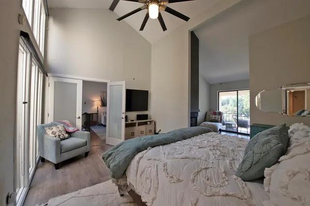 a bedroom with a balcony a bed and a couch