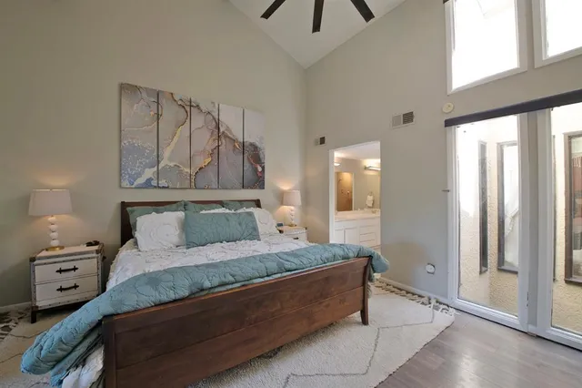 a bedroom with a large bed and a window