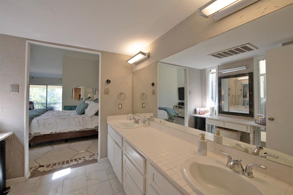 3915 Roma Court Rockwall, TX 75087 - Photo 24 of 40 Full bath with ensuite bath, double vanity, and light marble finish floors