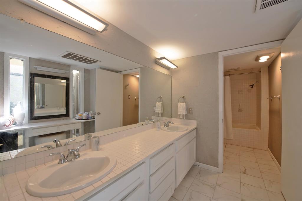 3915 Roma Court Rockwall, TX 75087 - Photo 25 of 40 Full bathroom featuring double vanity and light marble finish floors