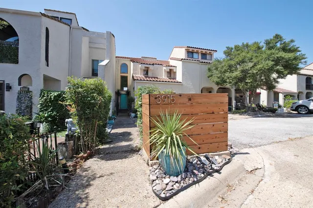 a front view of multiple houses with yard