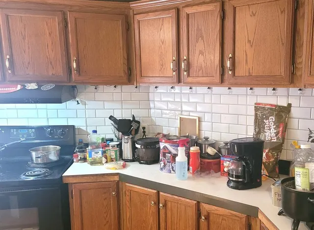 a kitchen with a sink and wooden cabinets
