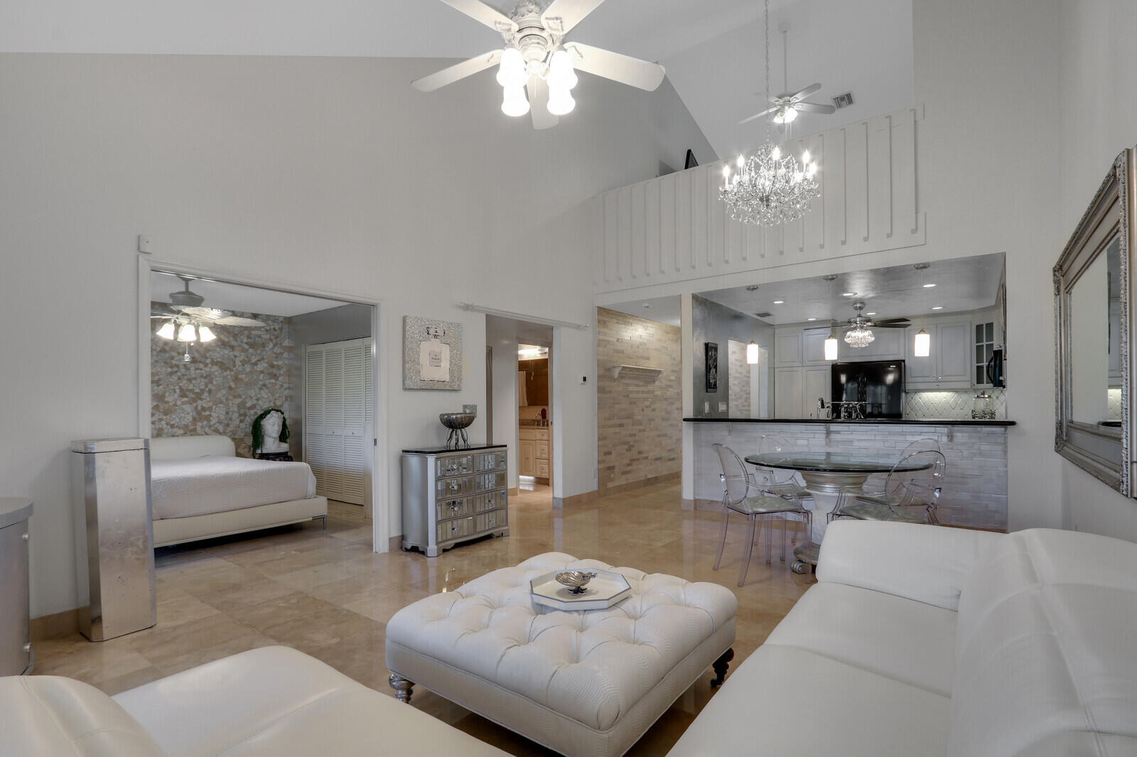6136 Southeast Georgetown Place Hobe Sound, FL 33455 - Photo 1 of 46 a living room with furniture and a chandelier