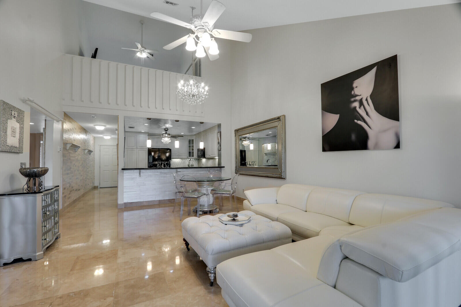 6136 Southeast Georgetown Place Hobe Sound, FL 33455 - Photo 13 of 46 a living room with furniture and a chandelier