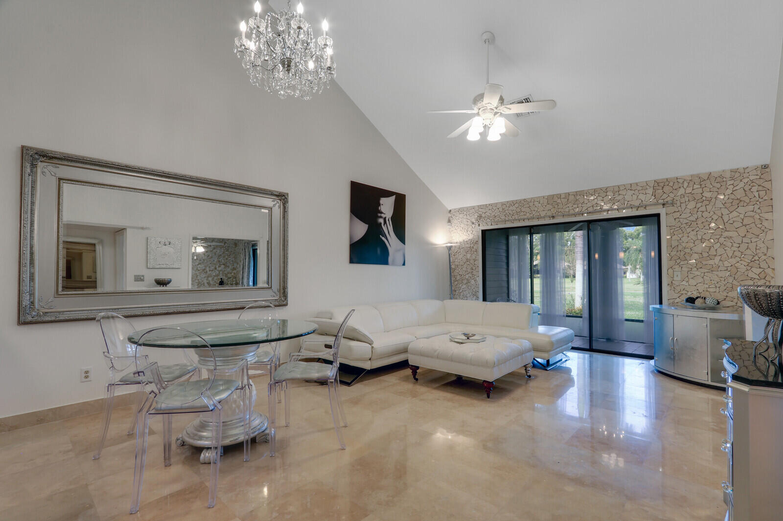 6136 Southeast Georgetown Place Hobe Sound, FL 33455 - Photo 14 of 46 a living room with furniture and chandelier