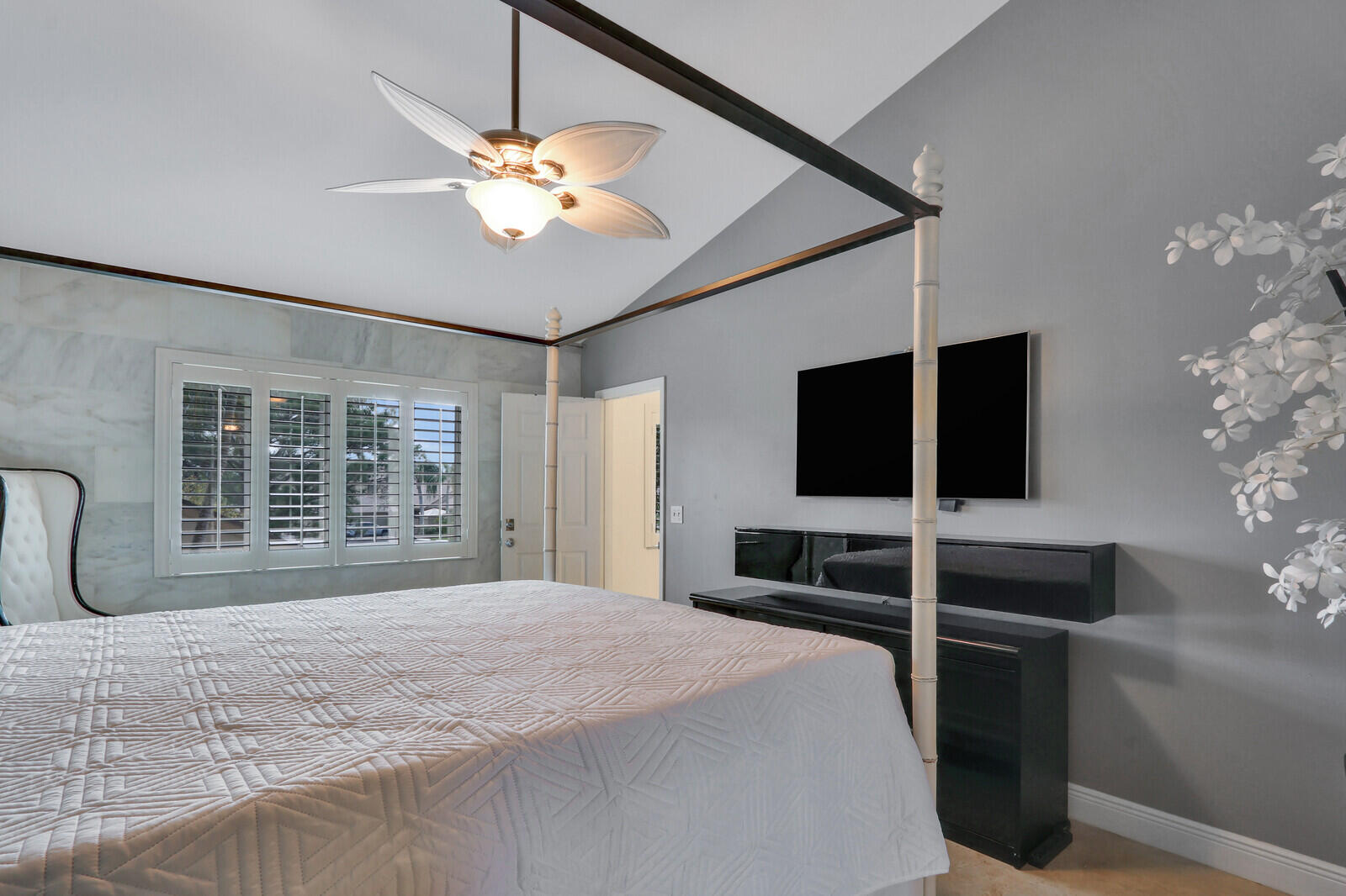6136 Southeast Georgetown Place Hobe Sound, FL 33455 - Photo 27 of 46 a bedroom with a large bed and a window