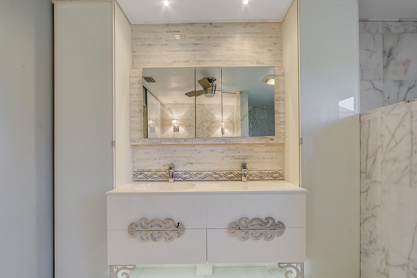 6136 Southeast Georgetown Place Hobe Sound, FL 33455 - Photo 29 of 46 a bathroom with a sink and a mirror