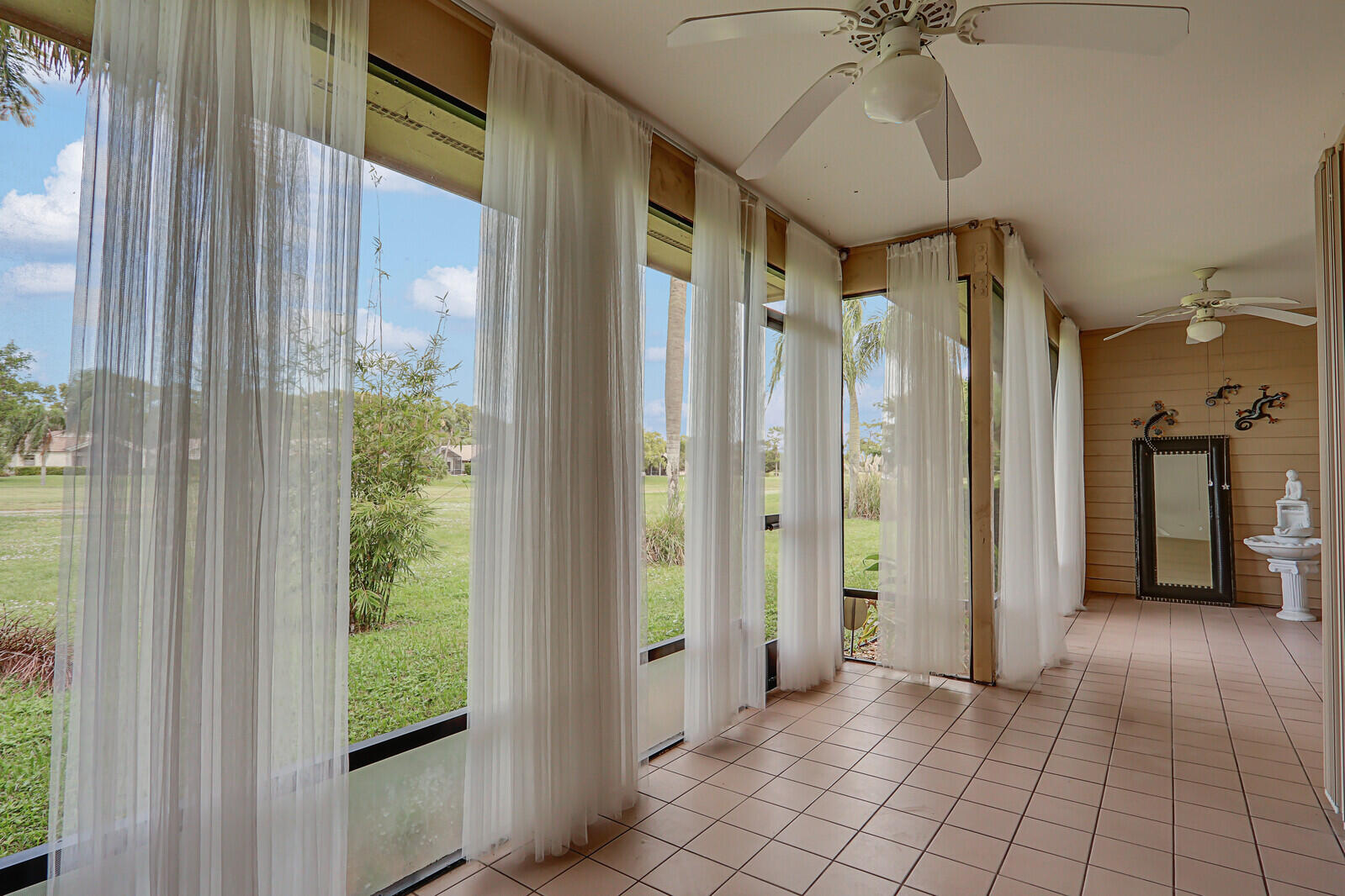 6136 Southeast Georgetown Place Hobe Sound, FL 33455 - Photo 35 of 46 a view of a hallway with windows