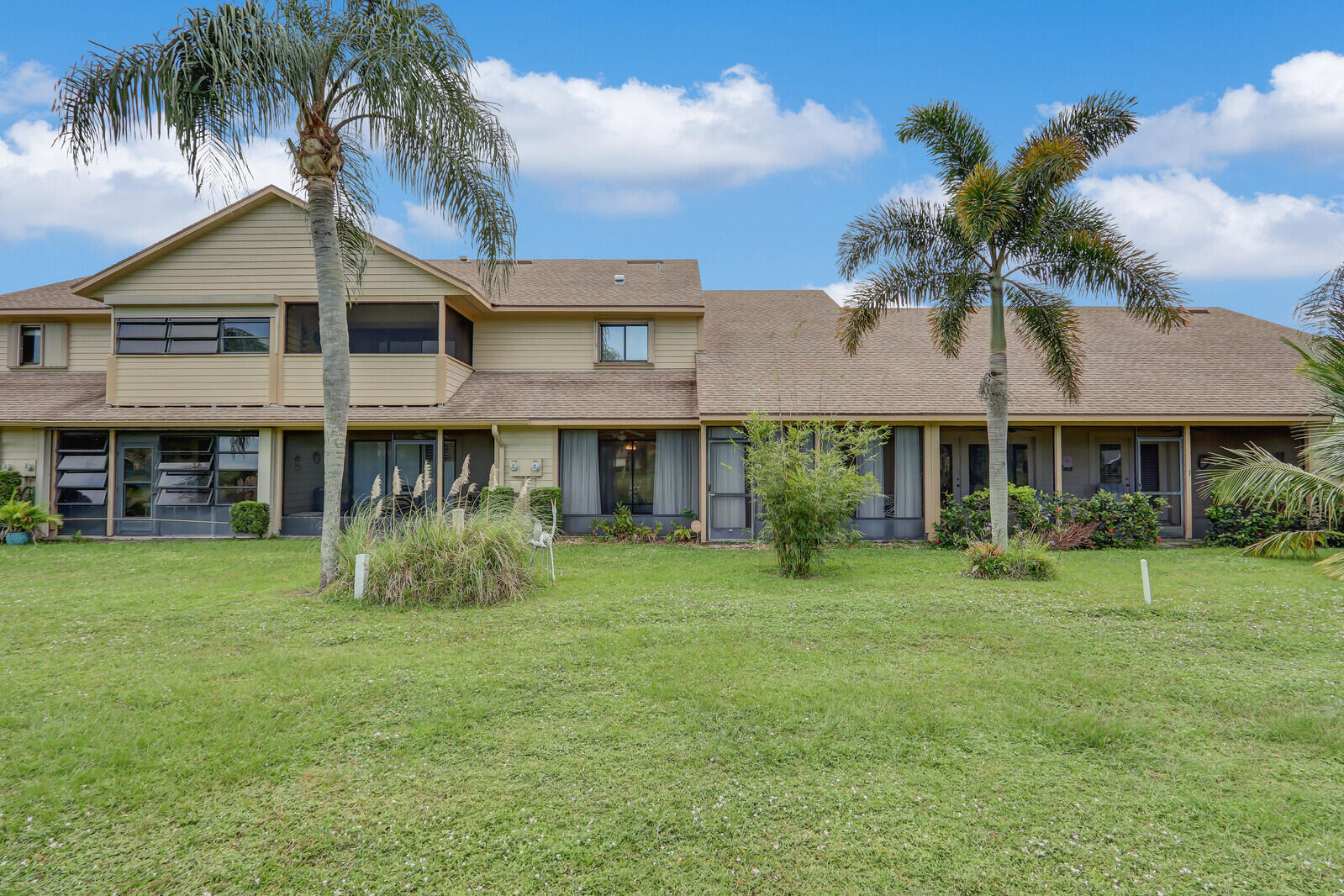 6136 Southeast Georgetown Place Hobe Sound, FL 33455 - Photo 38 of 46 a front view of a house with a yard
