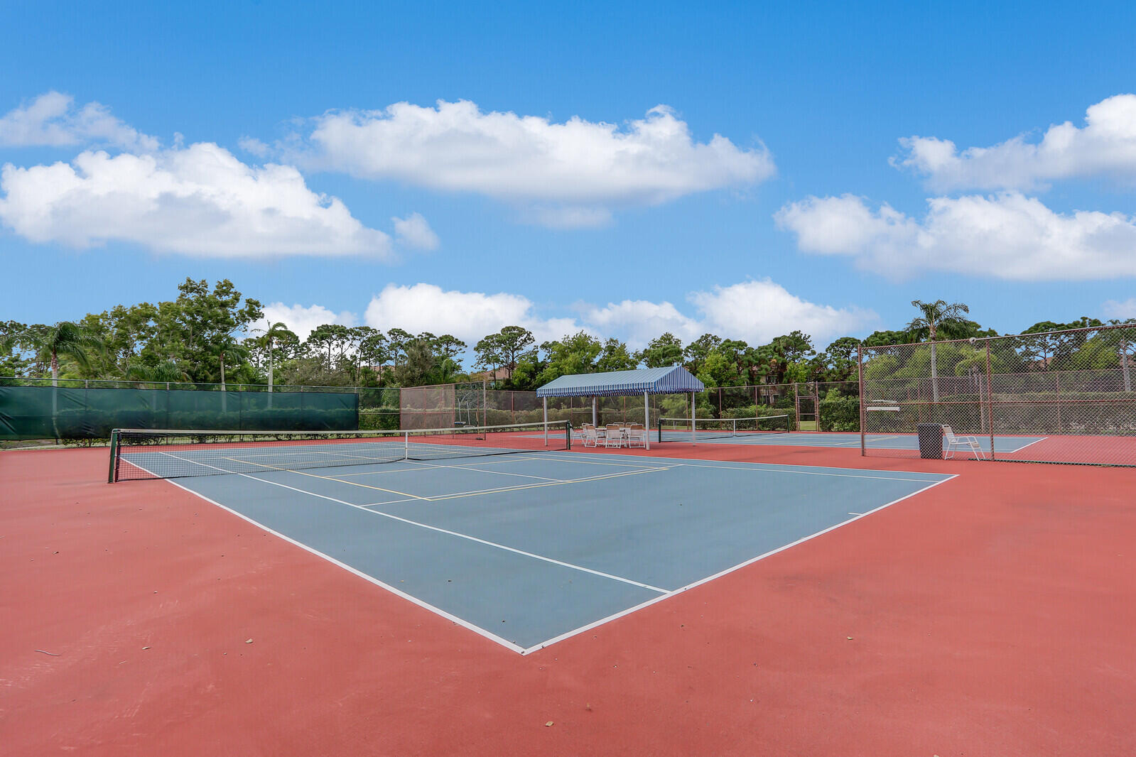 6136 Southeast Georgetown Place Hobe Sound, FL 33455 - Photo 44 of 46 a view of a tennis court