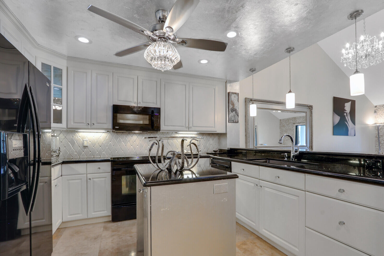 6136 Southeast Georgetown Place Hobe Sound, FL 33455 - Photo 5 of 46 a kitchen with a sink stainless steel appliances a counter space and cabinets