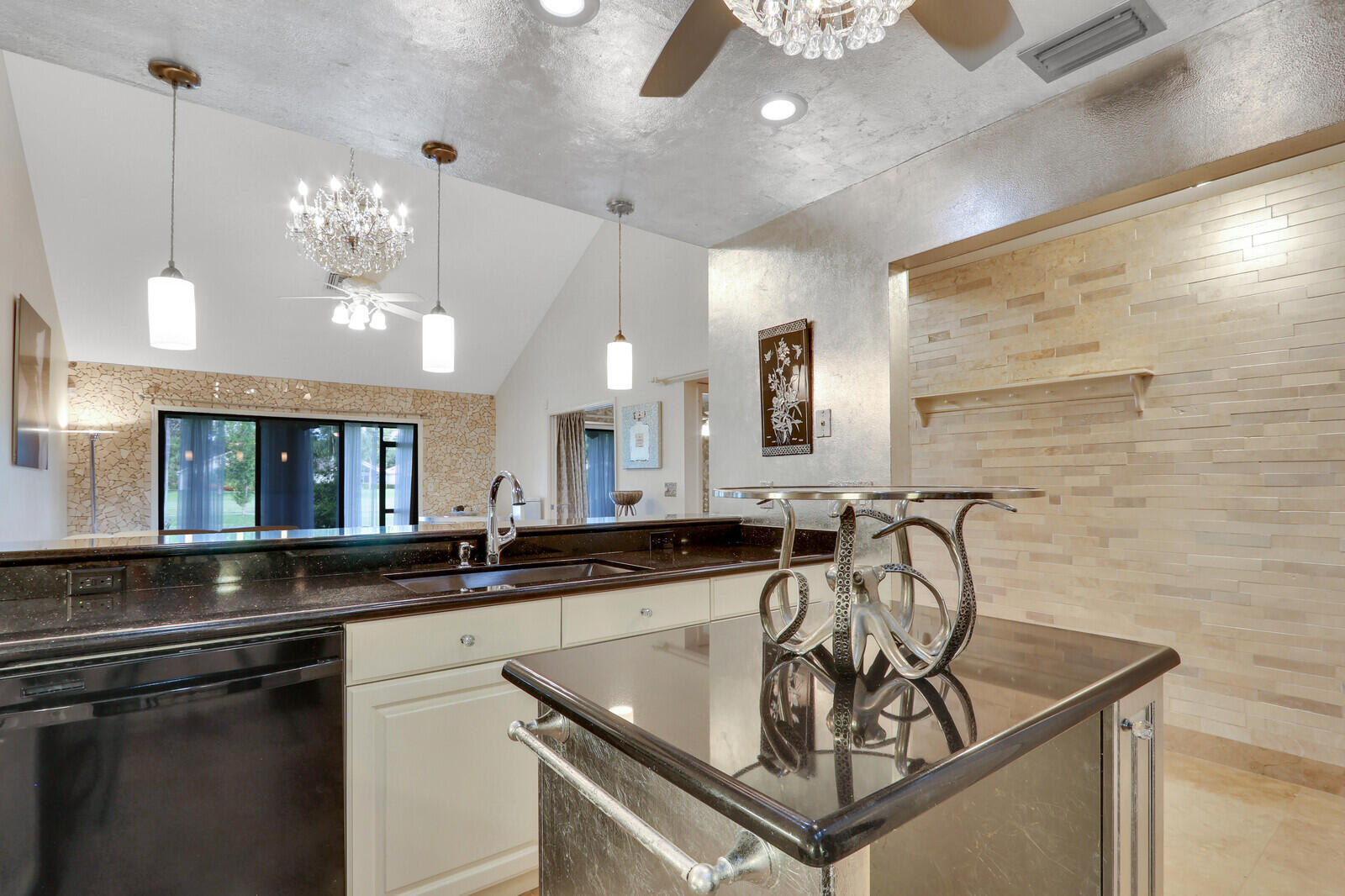 6136 Southeast Georgetown Place Hobe Sound, FL 33455 - Photo 7 of 46 a kitchen with stainless steel appliances granite countertop a sink a counter space and cabinets
