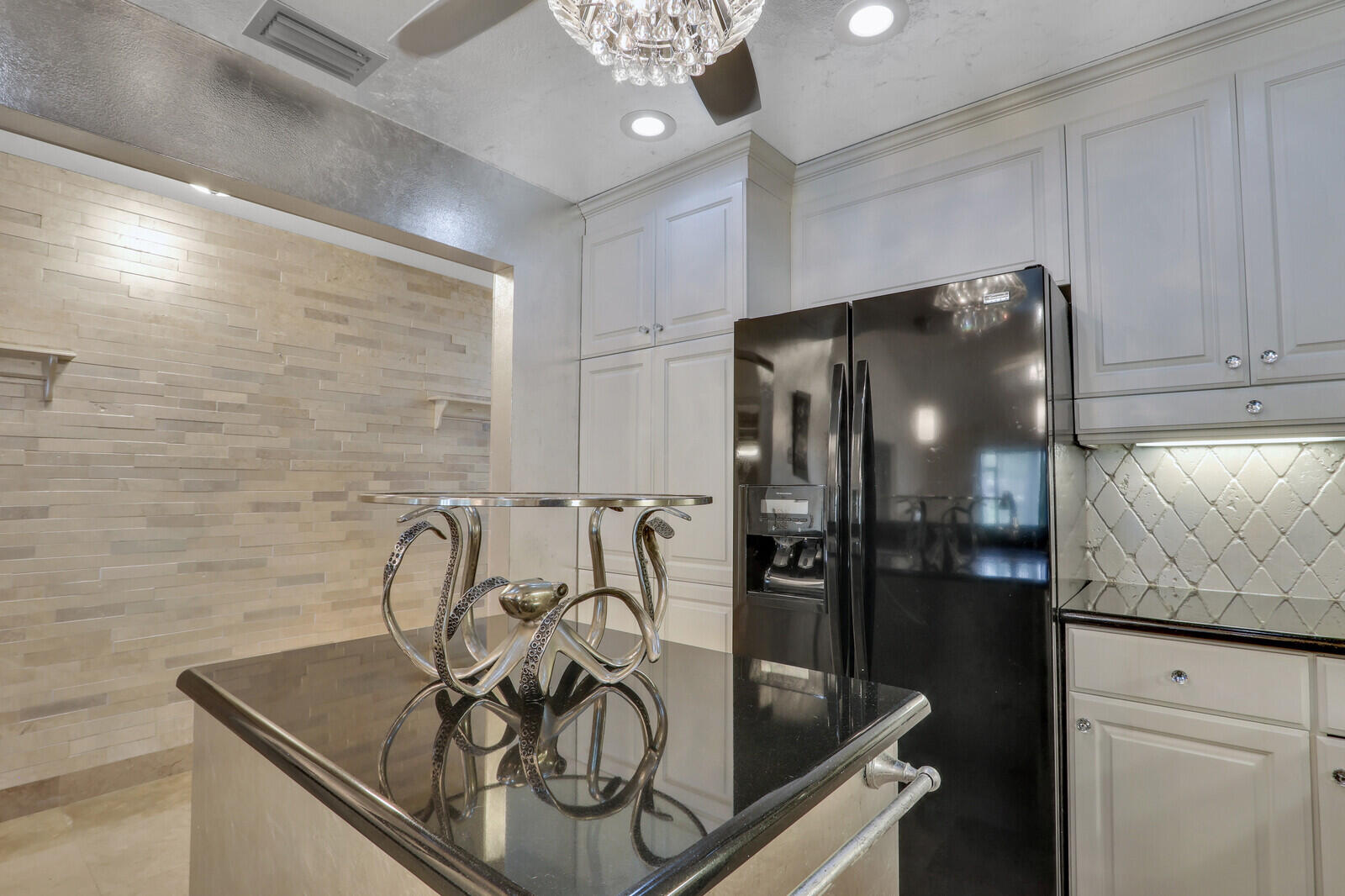 6136 Southeast Georgetown Place Hobe Sound, FL 33455 - Photo 8 of 46 a kitchen with a refrigerator and cabinets
