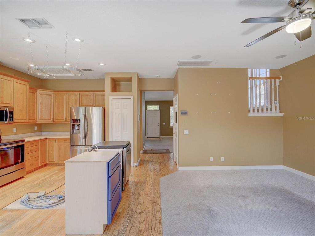 2217 Rising Creek Court Dunedin, FL 34698 - Photo 17 of 45 a large room with kitchen island a sink a counter space and stainless steel appliances