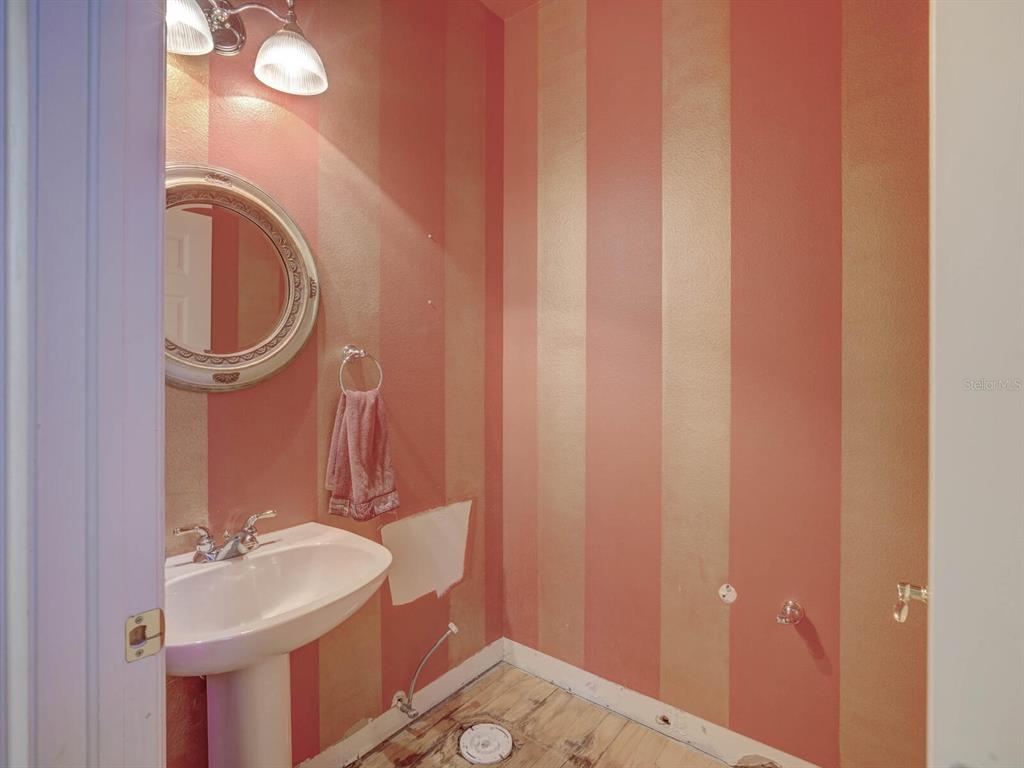 2217 Rising Creek Court Dunedin, FL 34698 - Photo 18 of 45 a bathroom with a sink and a mirror