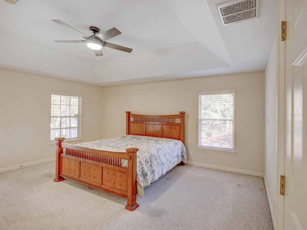 2217 Rising Creek Court Dunedin, FL 34698 - Photo 21 of 45 a bedroom with a bed and window