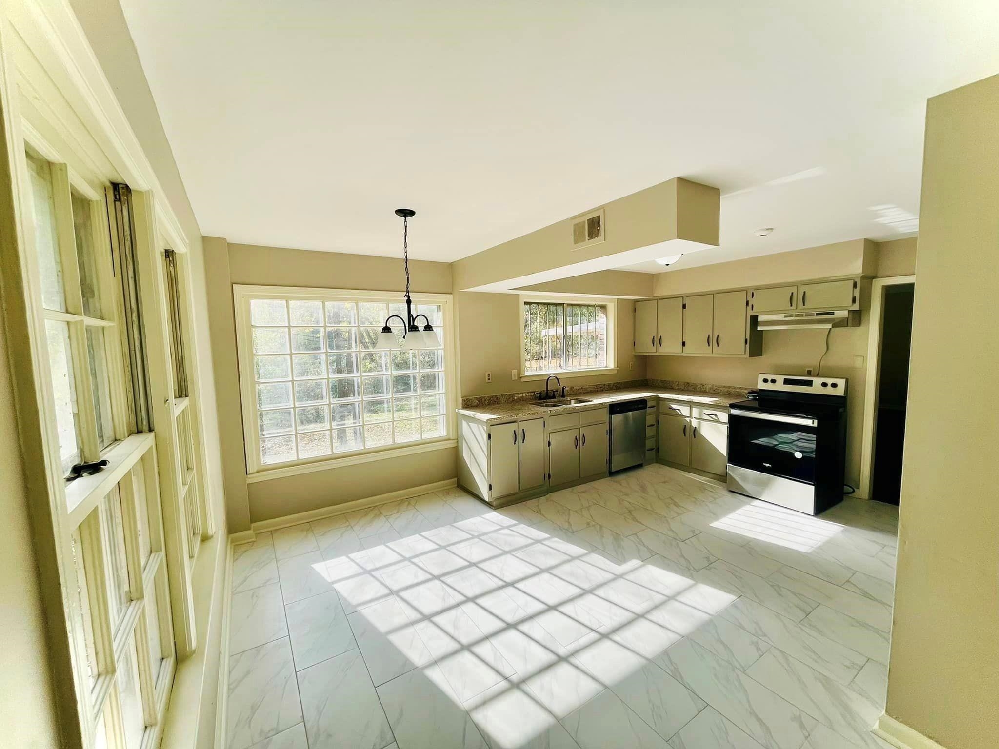 3013 Dumbarton Road Memphis, TN 38128 - Photo 3 of 7 a large white kitchen with a sink stainless steel appliances and cabinets