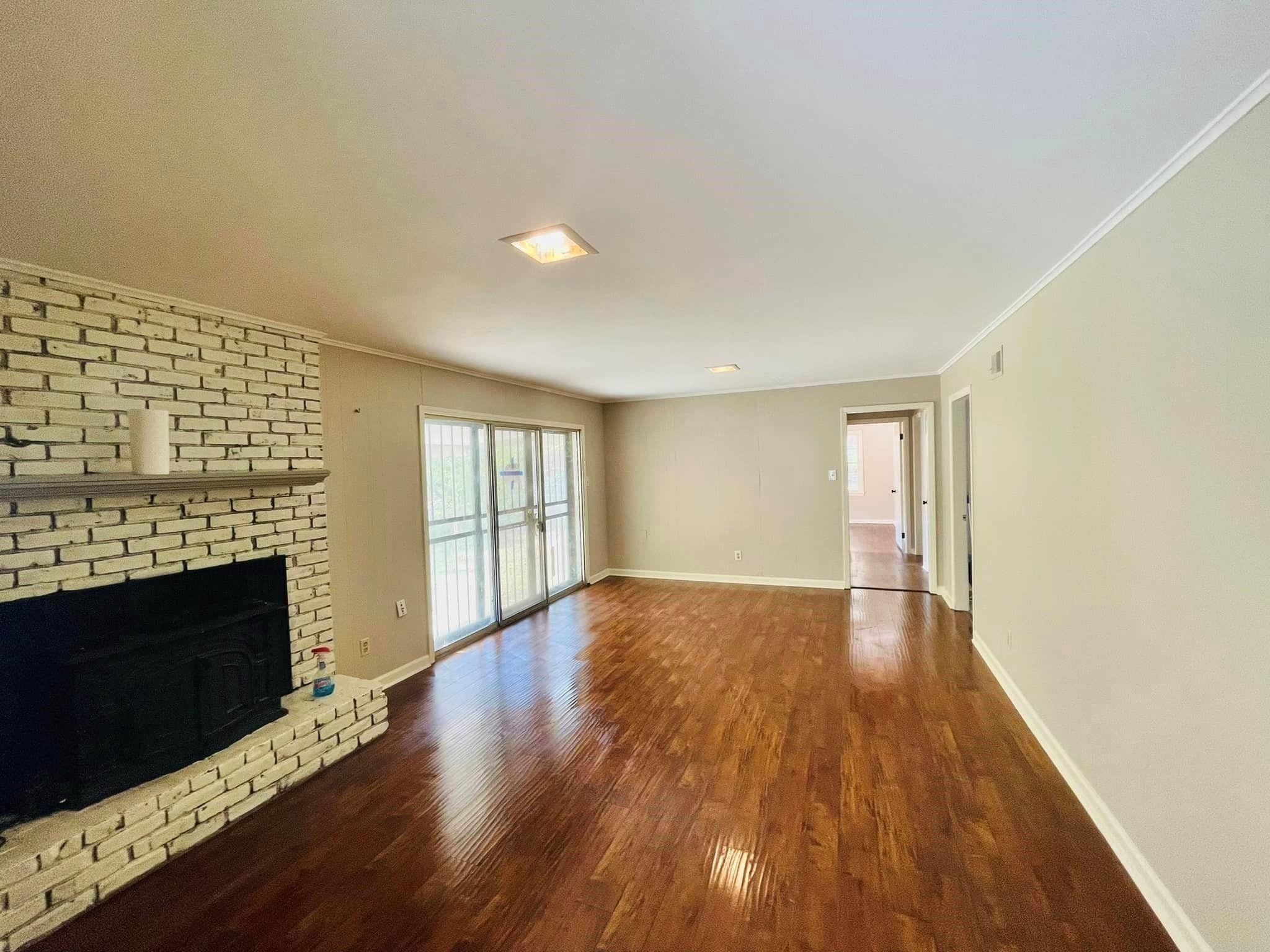 3013 Dumbarton Road Memphis, TN 38128 - Photo 5 of 7 a view of an empty room with wooden floor and a fireplace