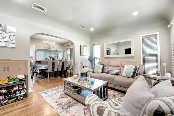 a living room with furniture and wooden floor