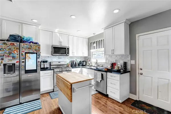 a kitchen with a sink stove and refrigerator