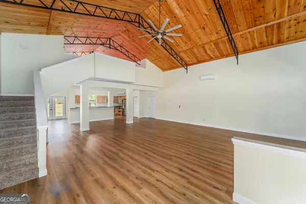 a view of a room with wooden floor