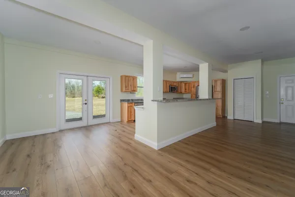 a view of a kitchen with wooden floor and a sink