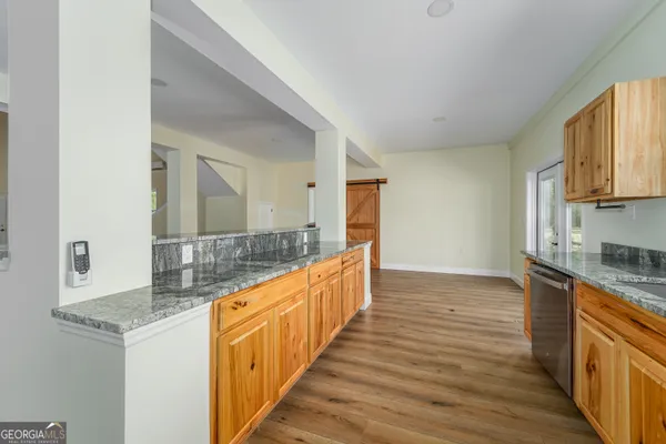 a bathroom with granite countertop a sink and a wooden floor