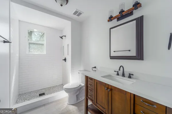 a bathroom with a toilet sink and shower