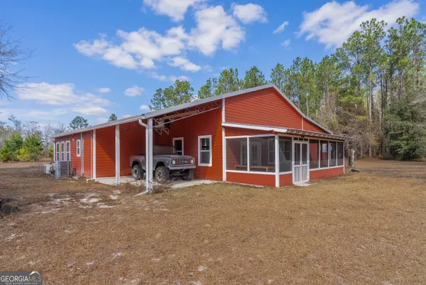 a view of a house with backyard porch and sitting area
