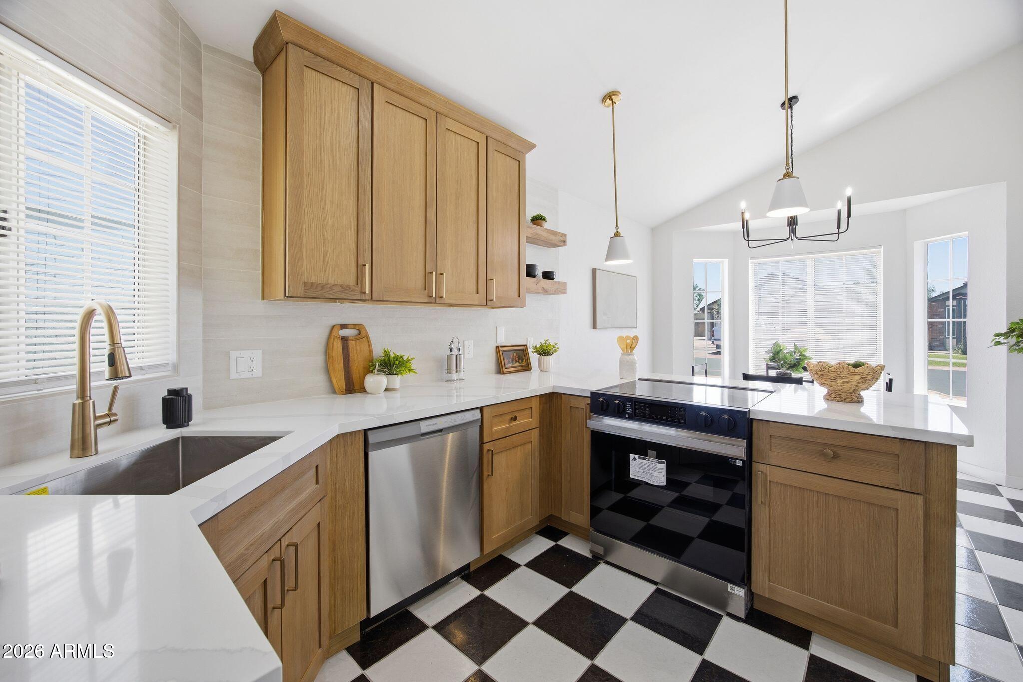 3134 East McKellips Road, Unit 69 Mesa, AZ 85213 - Photo 9 of 24 a kitchen with a sink a stove and cabinets