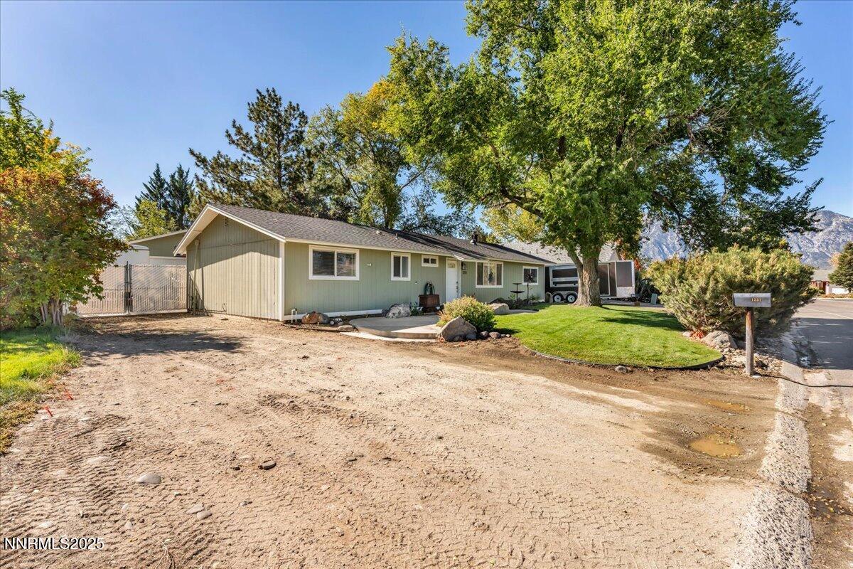 1231 Manhattan Way Gardnerville, NV 89460 - Photo 40 of 45 a front view of house with yard and green space