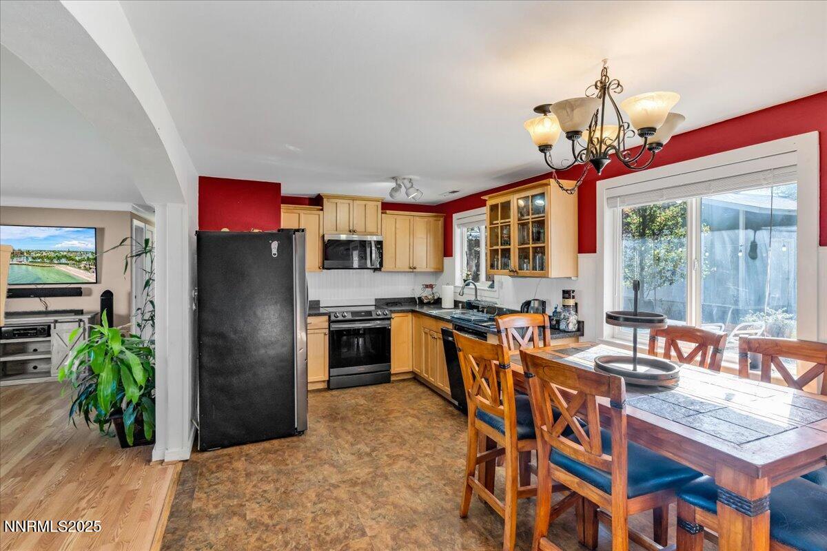 1231 Manhattan Way Gardnerville, NV 89460 - Photo 9 of 45 a large kitchen with a table and chairs