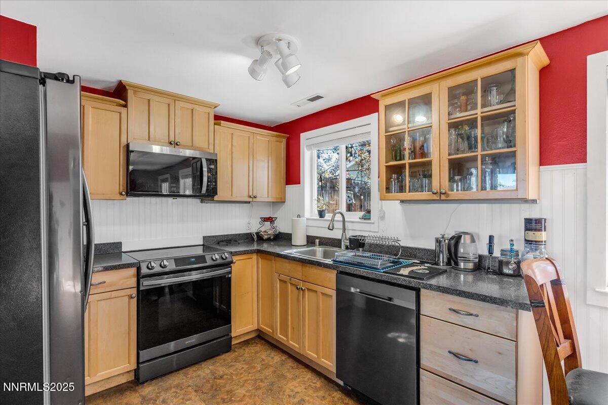 1231 Manhattan Way Gardnerville, NV 89460 - Photo 10 of 45 a kitchen with granite countertop a sink stainless steel appliances and cabinets